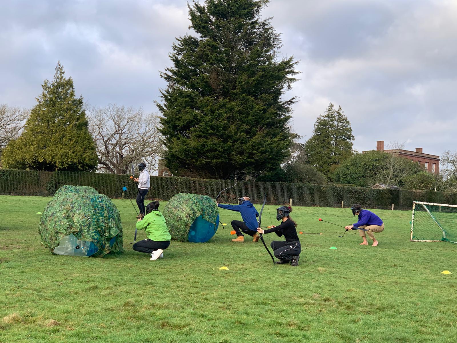London Student Mission members playing archery outdoors