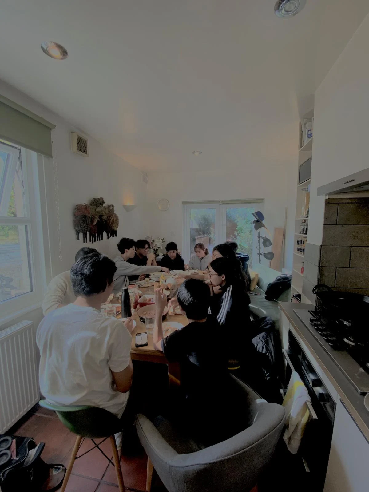 London Student Mission members sharing dinner around a kitchen table