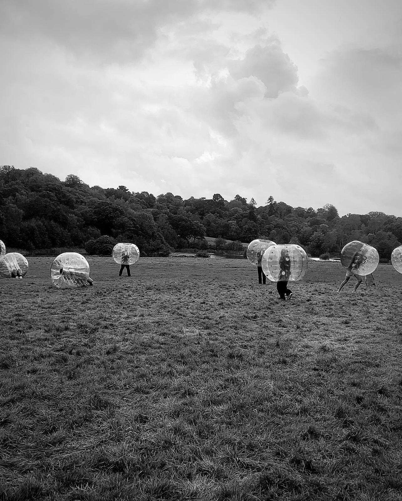 London Student Mission members playing bubble football in a field